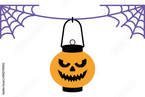 Jack o lantern hangs from a spooky spider web for the fall holiday.