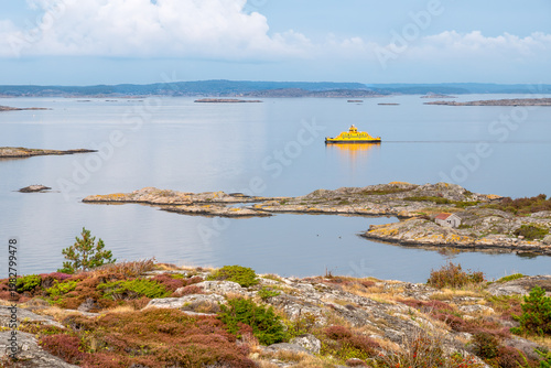 Yellow ferry among rocky skerries viewed from Hyppeln island in northern Gothenburg archipelago, Bohuslän, west coast Sweden