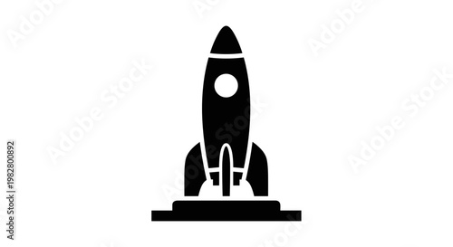 Black rocket on launch pad.