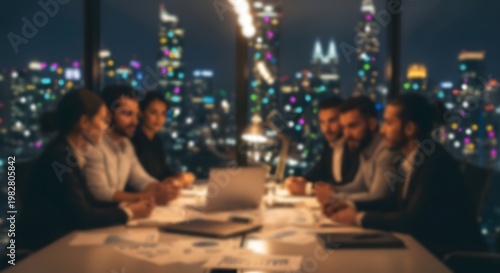 A group of young professionals collaborate on a laptop at a table overlooking a vibrant city skyline at night