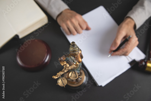 Statue of Lady Justice. Judge working in office