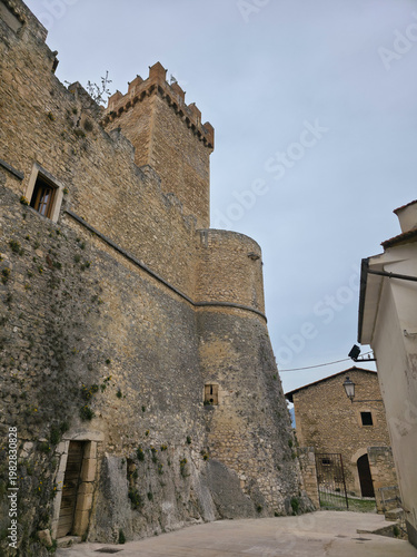 Low Angle View of the Medieval Piccolomini Castle with Imposing Stone Walls and Defensive Tower in Capestrano, Abruzzo, Italy