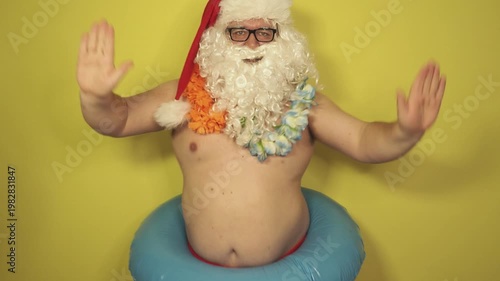 Santa Claus dreams of a seaside vacation with an inflatable ring