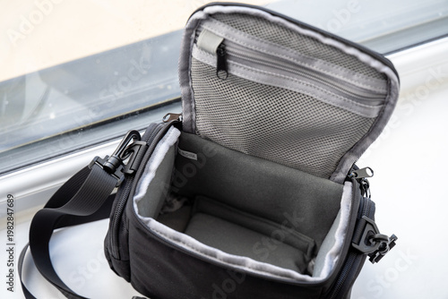 Open empty camera bag on windowsill