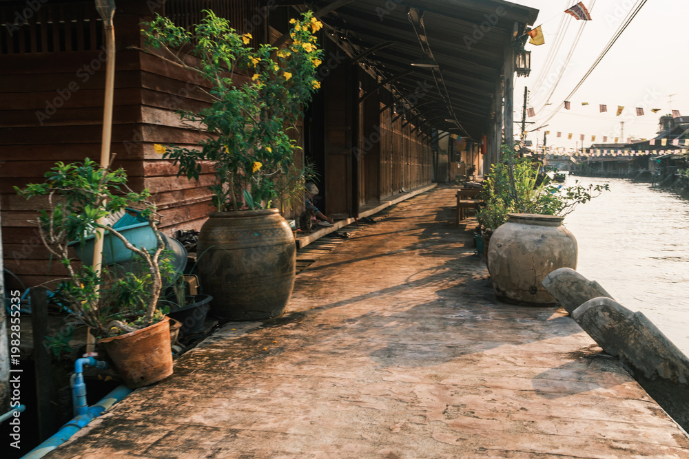 Naklejka premium he historic Amphawa canal lined with traditional Thai wooden houses and riverside shops, Bangkok, Thailand