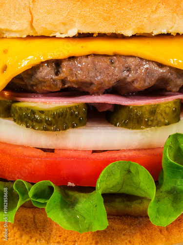 Juicy cheeseburger with fresh ingredients close up