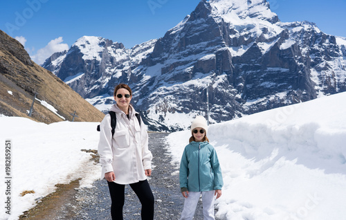 women with daughter hiking in the Swiss Alps mountains during vacation, Grindelwald, First Cliff Walk