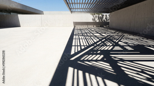 Shadows created by architectural design on a concrete surface during bright daylight