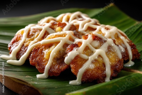 Fried Banana with Melted Cheese Drizzle on Banana Leaf