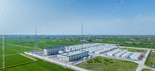Wallpaper Mural Aerial View of a Contemporary Grid-Scale Battery Storage Power Station Amidst Verdant Farmland and Wind Turbines Torontodigital.ca