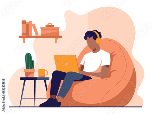 A man sits comfortably in a bean bag chair working on his laptop at home