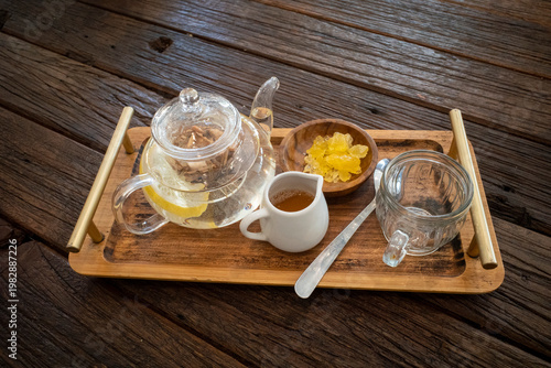 A set of herbal drinks with lemongrass, tea, ginger, honey and various rhizomes, on an old wooden table