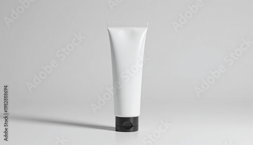 white cosmetic tube with black cap on gray background