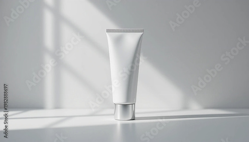 white cosmetic tube on gray surface with sunlight