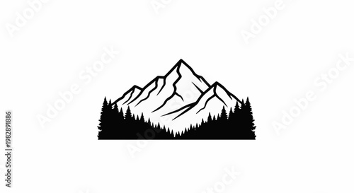 Silhouette of rugged mountains towering above a dense forest
