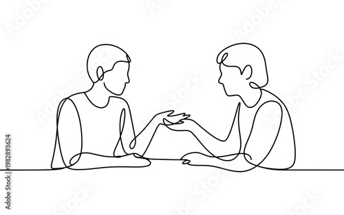 Two people sitting at a table and having a conversation with each other