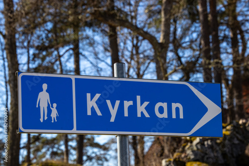 Roslags-Kulla, Sweden A road sign for pedestrians pointing to the Church, or Kyrka in Swedish.
