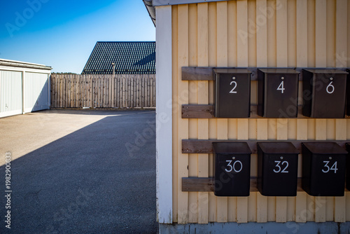 Akersberga, Sweden Numbered mailboxes in a residential parking lot.