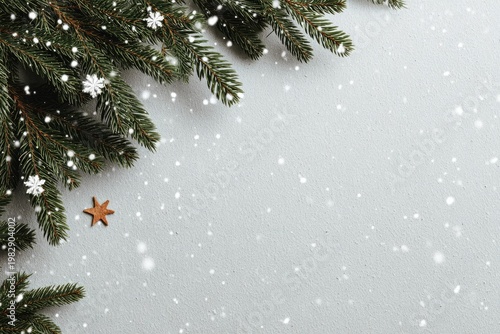 Festive winter scene with green evergreen branches, snow flakes, and a star