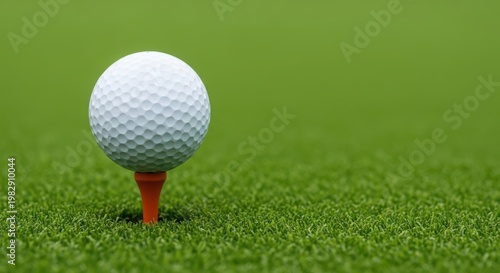 A white golf ball on an orange tee