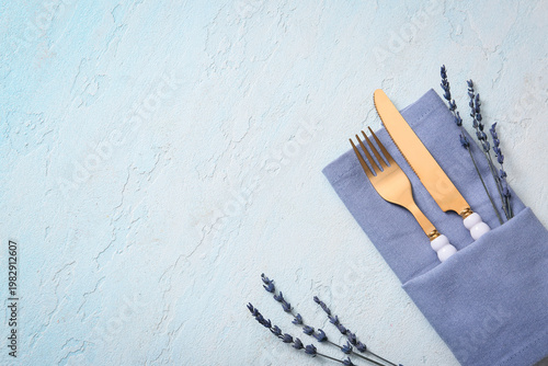 Golden cutlery with napkin ...
