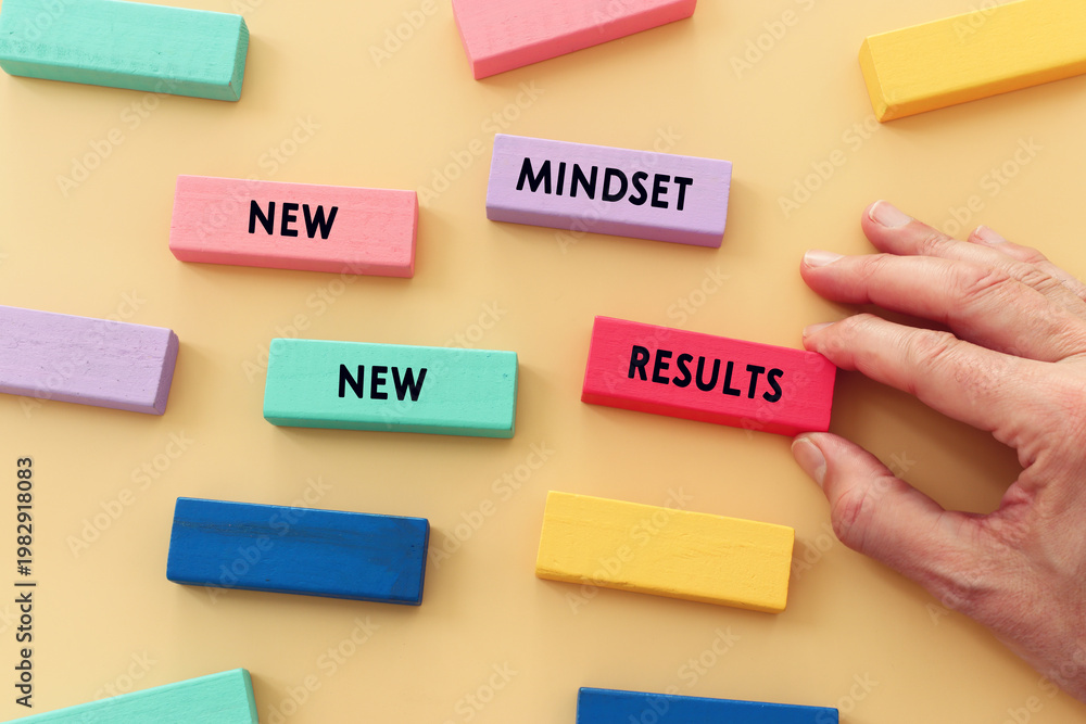 Obraz premium image of wooden cubes with the text new mindset and results. Success or personal development concept