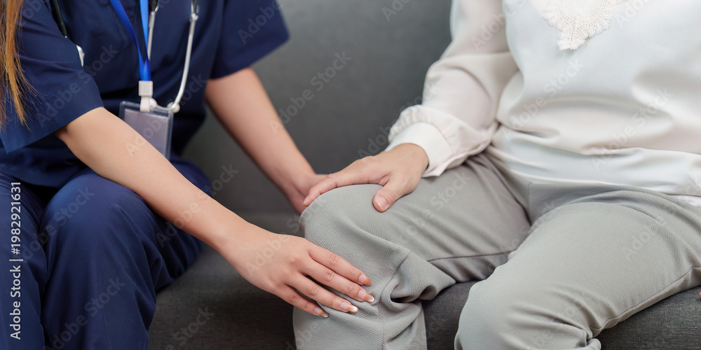 Fototapeta premium Nurse assisting elderly woman with knee pain