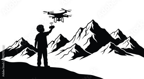 A young boy operates a drone controller while standing before a mountainous backdrop