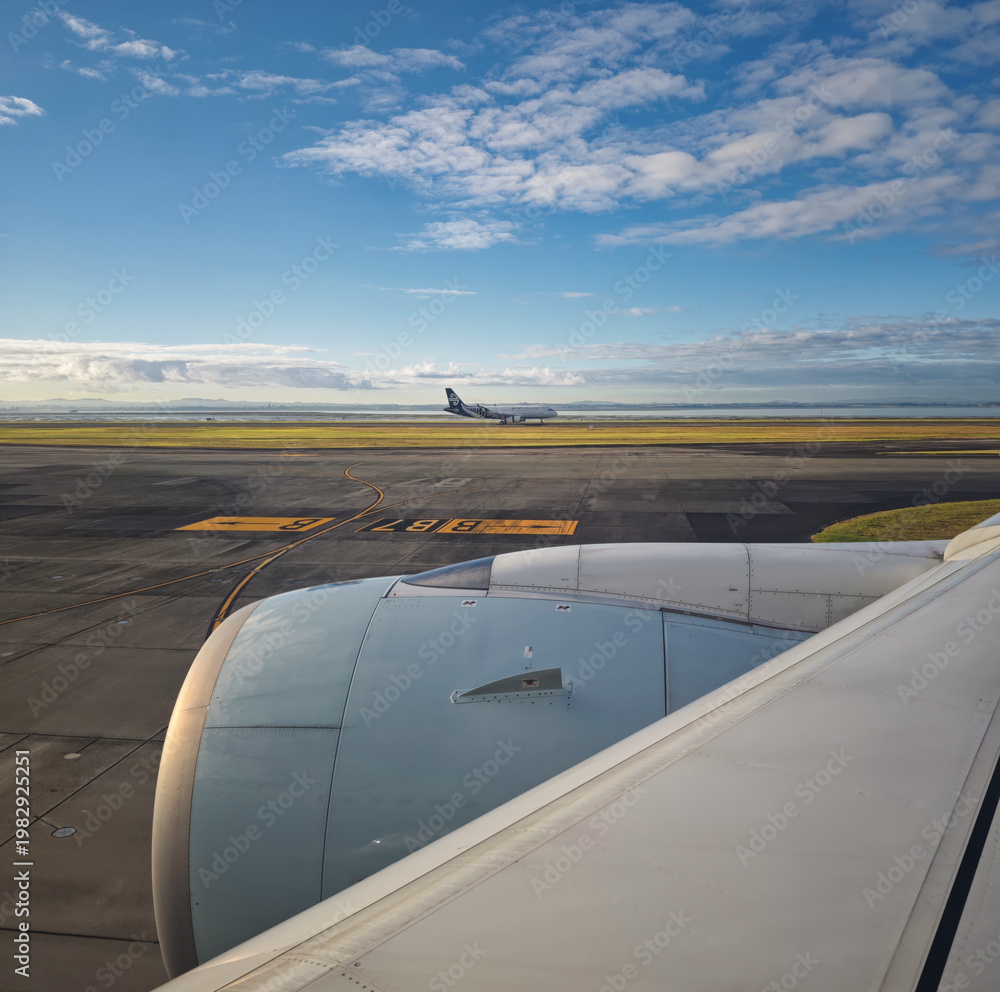 Fototapeta premium Air New Zealan Boeing 777-300 airplane waiting on runway at airport Auckland International with jet engine in front