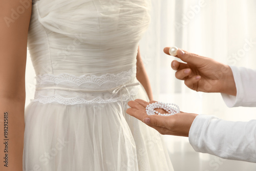 Woman with pearls fitting e...