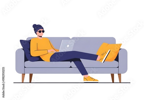 Relaxed young adult sitting on gray couch with laptop
