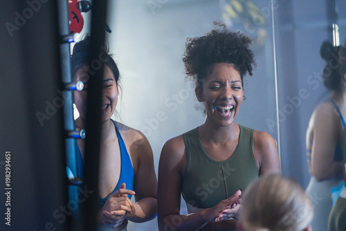 Принти на полотні Two fit women burst into laughter together during a gym break, capturing the joyful side of working out with a great friend
