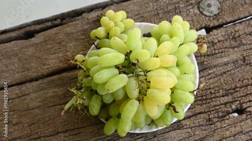 Fresh green grape or shine muscat grape fruit. Healthy eating. Fresh ripe grapes on wooden table, close up