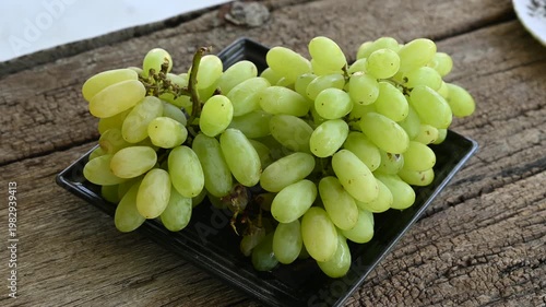 Fresh green grape or shine muscat grape fruit. Healthy eating. Fresh ripe grapes on wooden table, close up