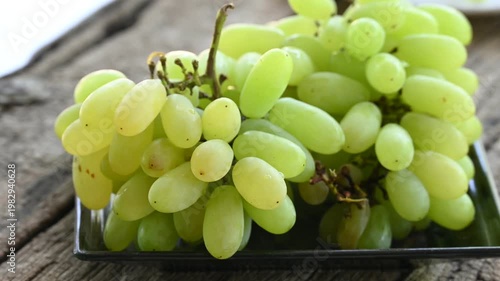 Fresh green grape or shine muscat grape fruit. Healthy eating. Fresh ripe grapes on wooden table, close up