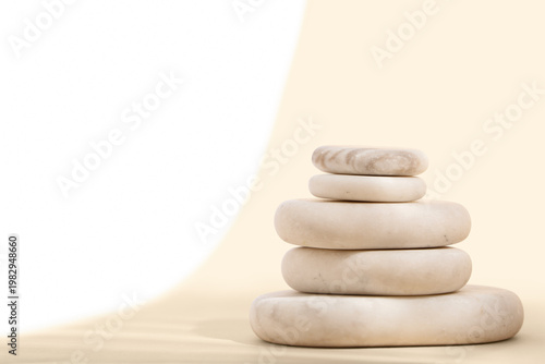 Stack of pebbles on color b...