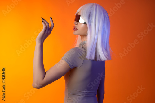 Young woman in wig with VR ...