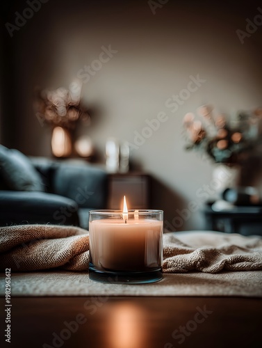 Lit candle on a soft surface in a minimalist space 