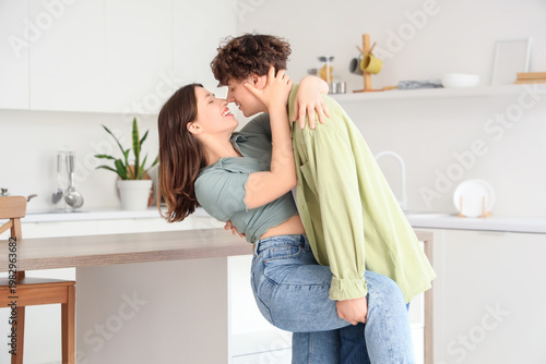 Young couple kissing in kit...