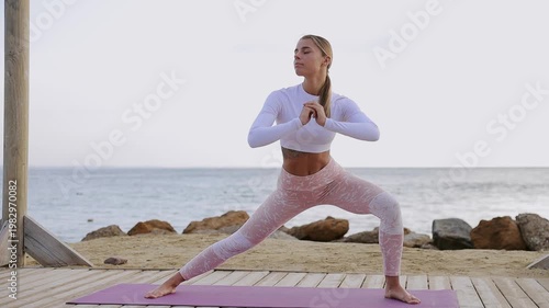 Full body young strong sporty athletic fit sportsman woman wears sports clothes do squats stretch legs warm up train at sunrise sun dawn over sea beach outdoor on pier seaside in summer day morning