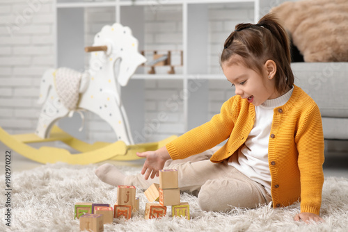 Happy little girl playing w...