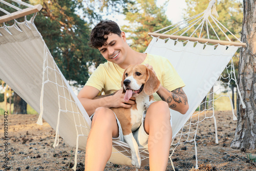 Young man with Beagle dog s...