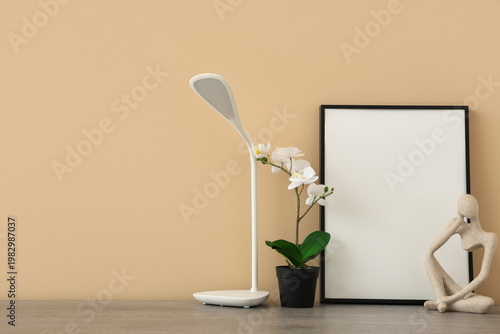 Table with lamp, flower and...