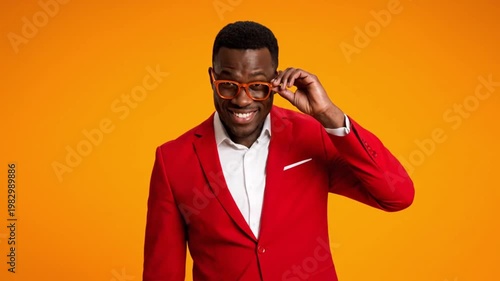 Wallpaper Mural Stylish African American Man Wearing a Vibrant Red Suit and Orange Glasses Smiling Confidently Against a Bright Yellow Background Torontodigital.ca