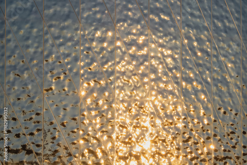 The fluted mirror reflects the golden evening light.