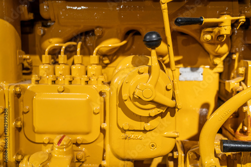 Close-Up of Vintage Tractor Engine in Yellow Industrial Detail