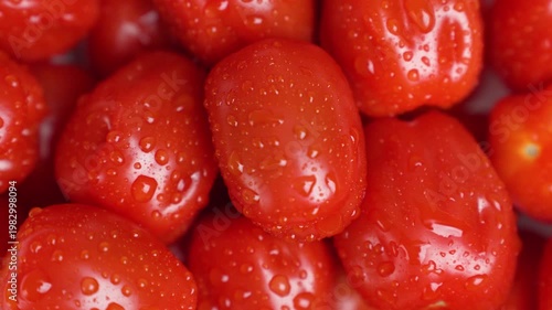 Vivid Depiction Of Rotating Cherry Tomatoes With Water Droplets Indicating Freshness And Purity
