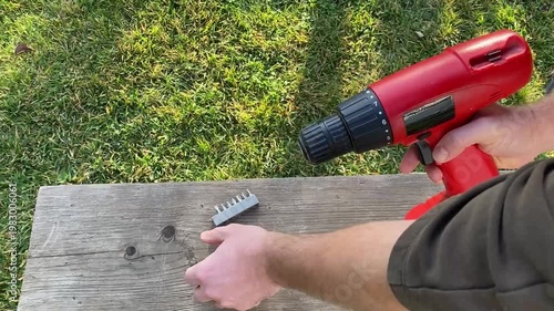 close view of hand controlling cordless screwdriver trigger adjusting speed power tool operation detail diy home repair and workshop equipment use