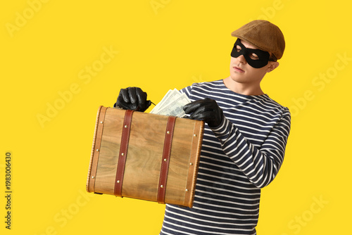 Male thief with briefcase o...