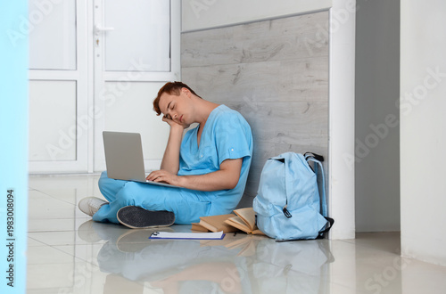 Tired male medical student ...